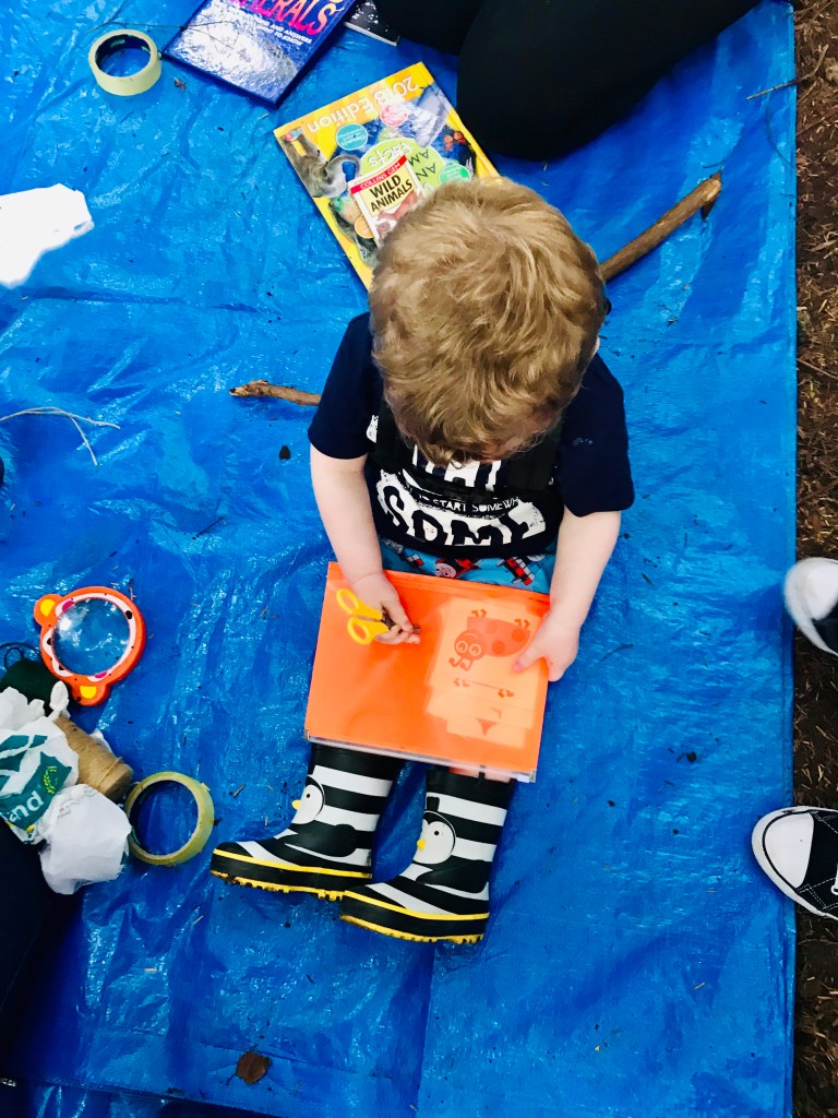 Reading all about bugs at our fun outdoor STEM sessions in Scotland
